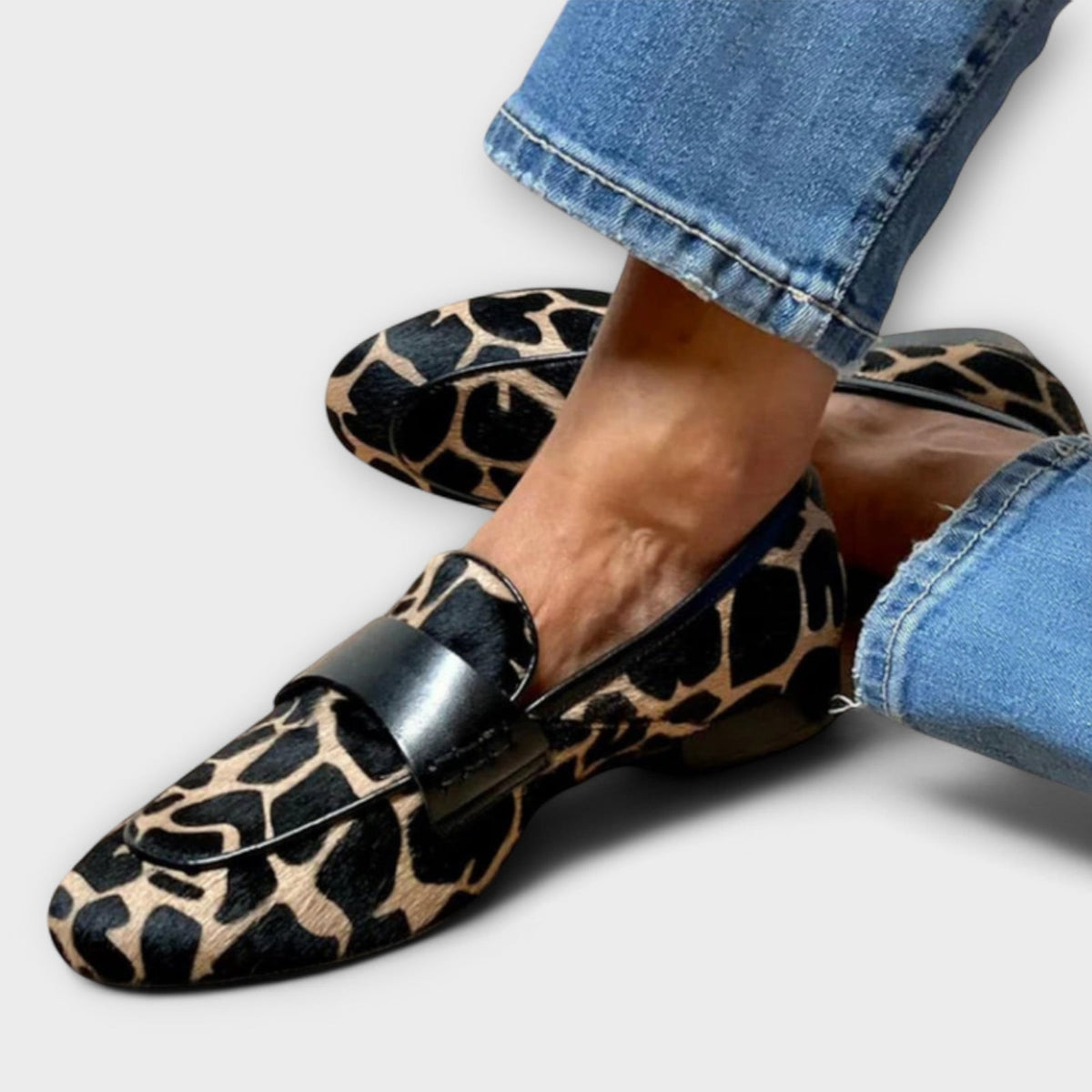Leopard print loafer with black patent strap, side view