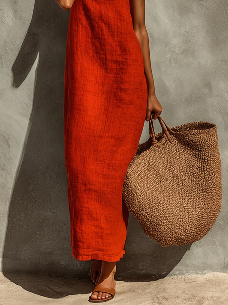 Side detail of the red maxi dress showing the textured fabric and straight column cut