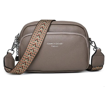Taupe crossbody bag with wide woven strap and front zip pocket