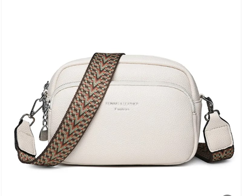Ivory crossbody bag with wide woven strap and front zip pocket