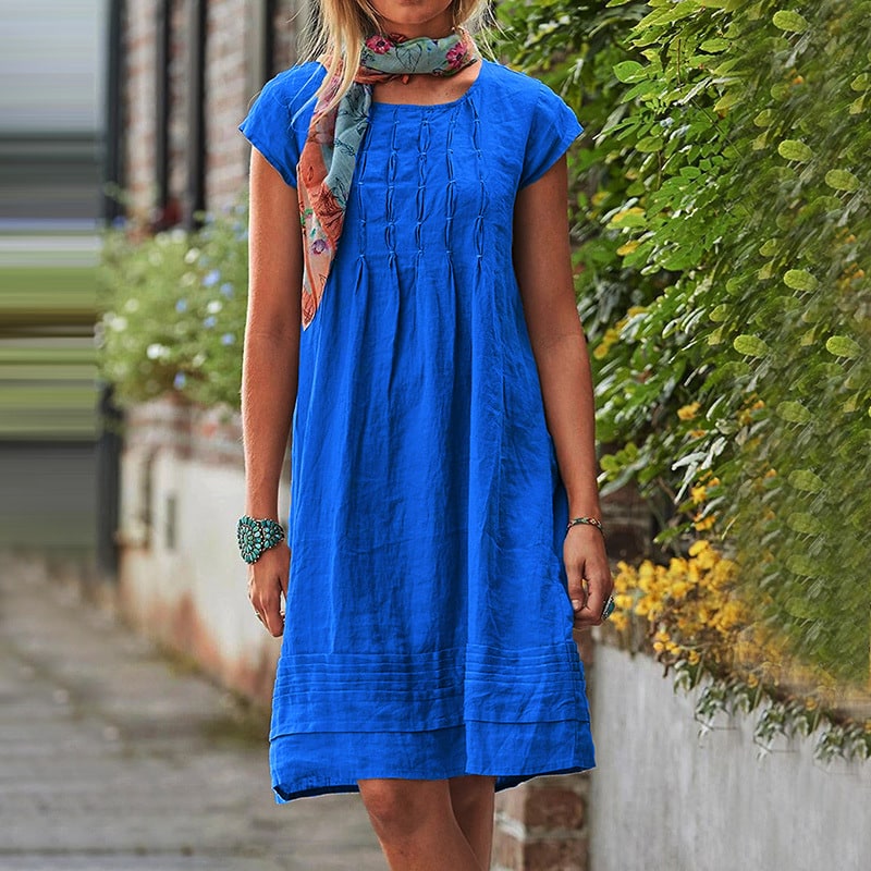 Royal blue loose summer dress with pintuck bodice worn outdoors