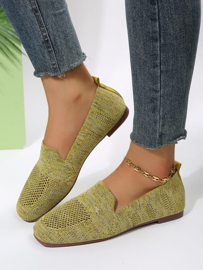 Olive knit square toe slip on flats worn with jeans