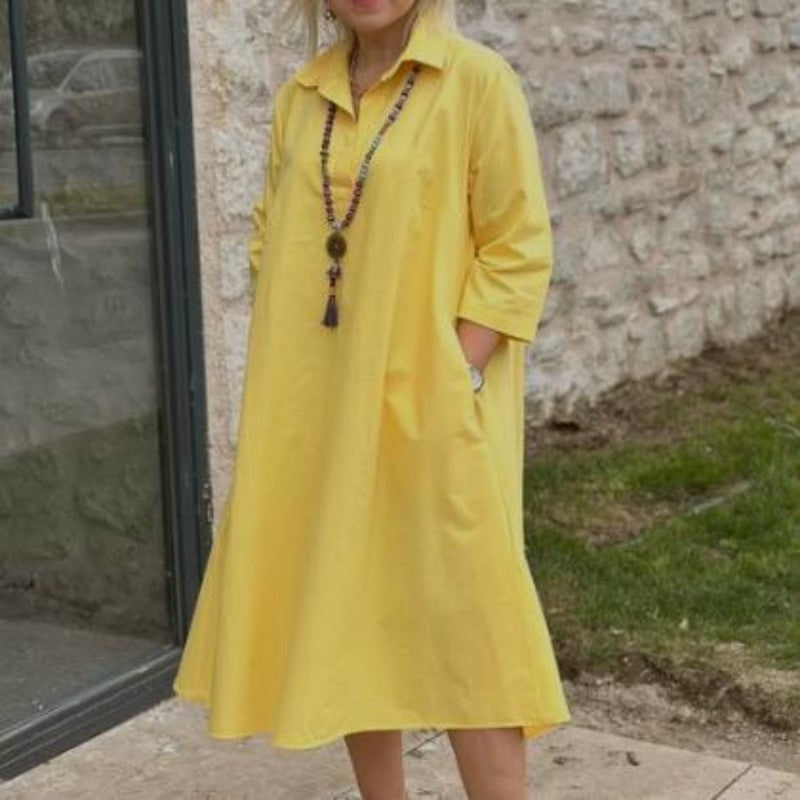 Yellow A-line midi dress with hands in side pockets 6