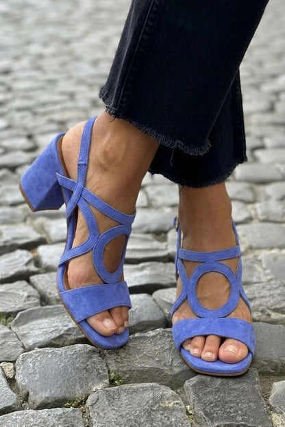 Periwinkle blue block heel cross strap sandals worn with black cropped jeans