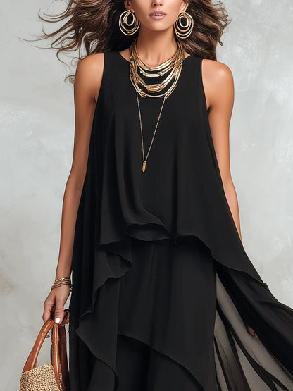 Black layered sleeveless maxi dress, front view showing the round neck and soft draped layers