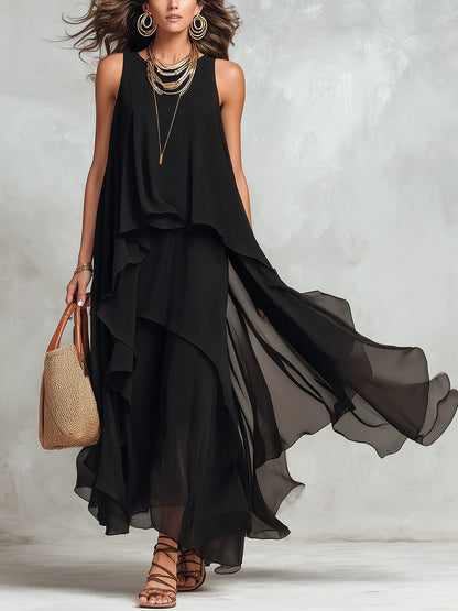 Black layered sleeveless maxi dress, full length view with flowing sheer tiered skirt