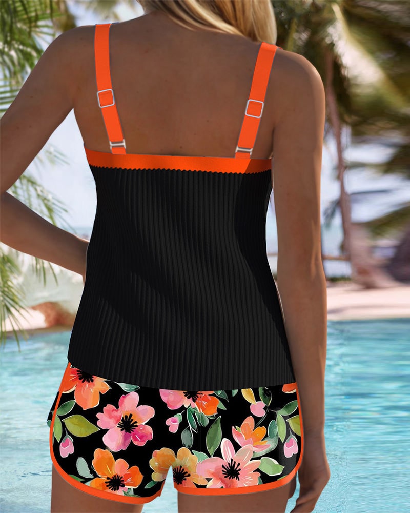 Back view of tankini top with orange straps and floral swim shorts