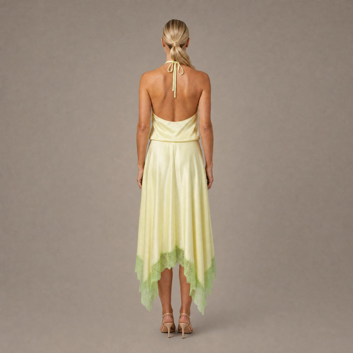 Back view of the key lime backless halter silk maxi dress showing the open back