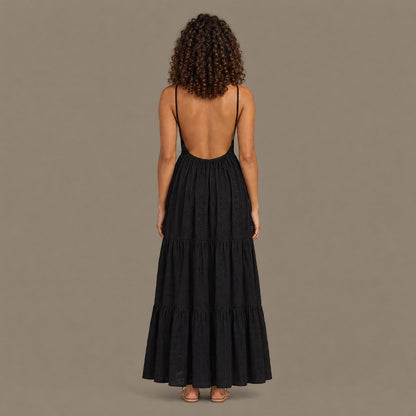 Back view of the black tiered maxi dress showing the open back and fine shoulder straps