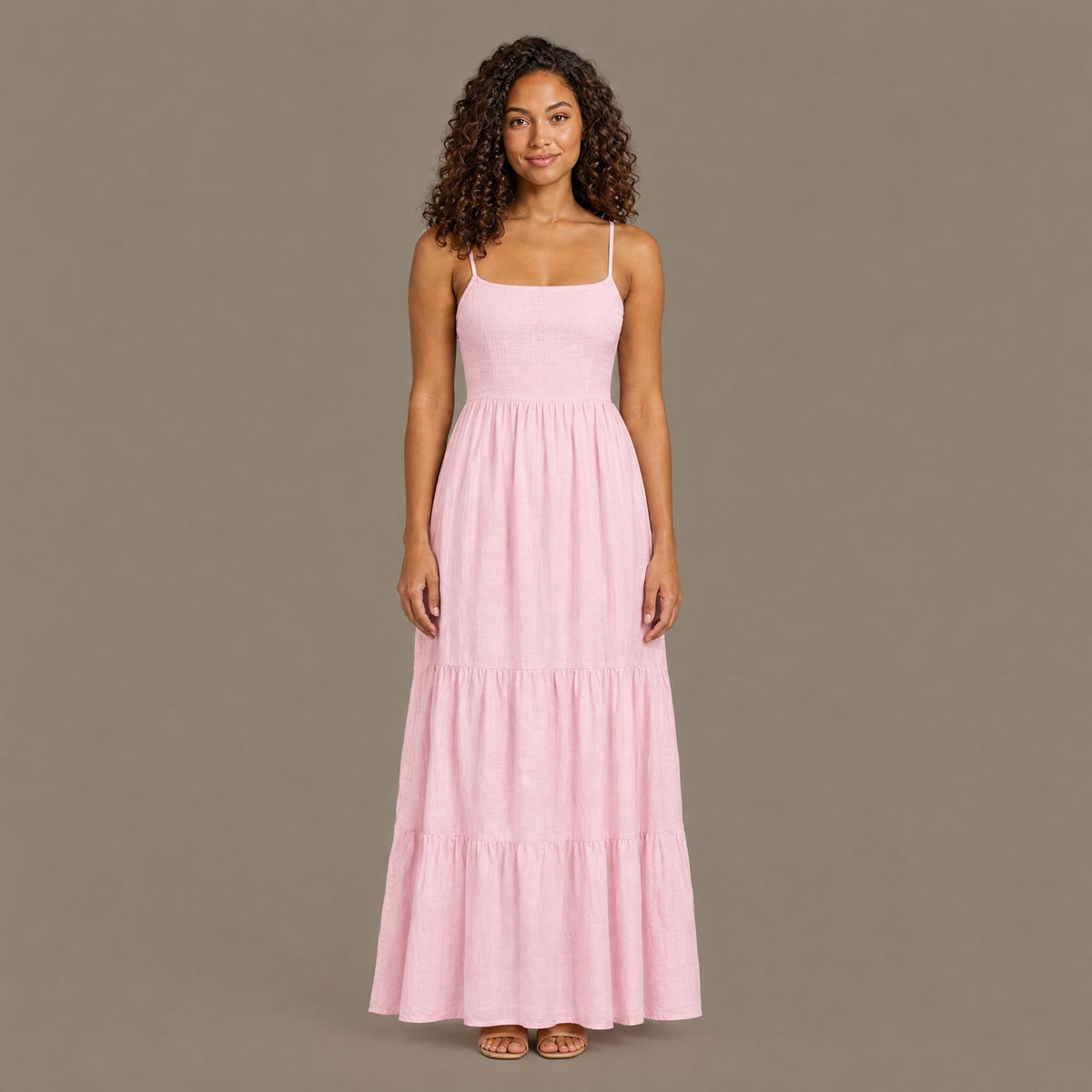 Woman wearing the pink backless tiered maxi dress, front view