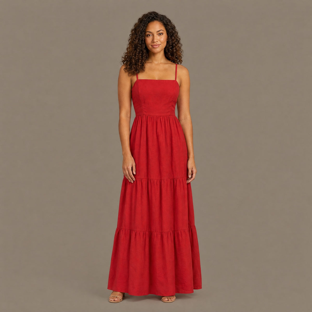 Woman wearing the red backless tiered maxi dress, front view