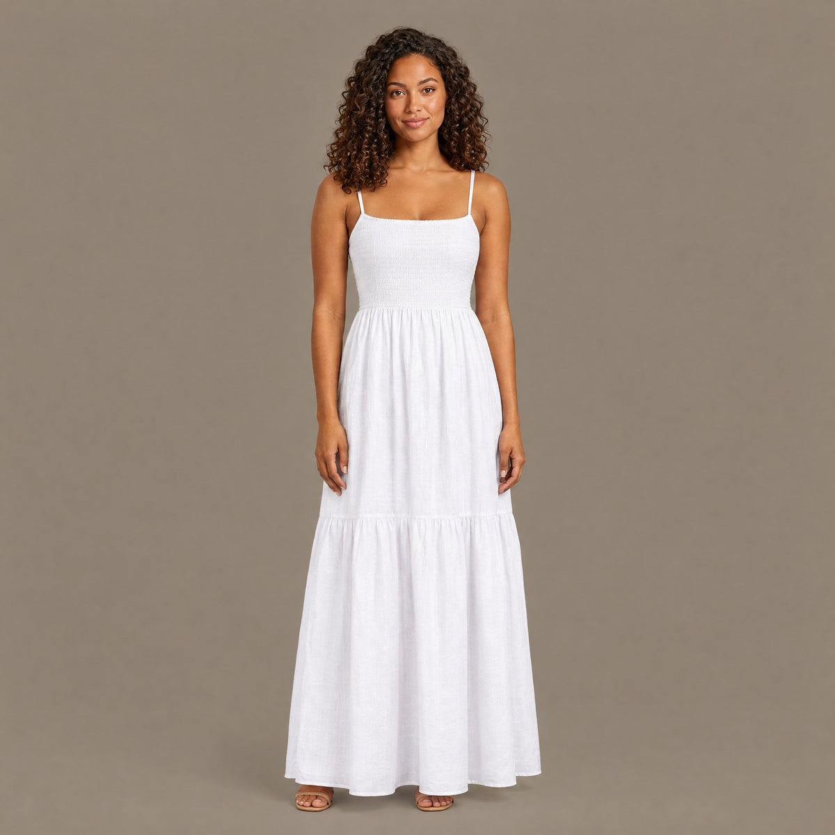 Woman wearing the white backless tiered maxi dress, front view