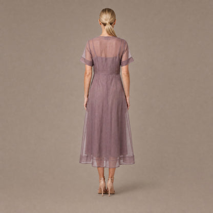 Back view of the mink organza A-line button front midi dress