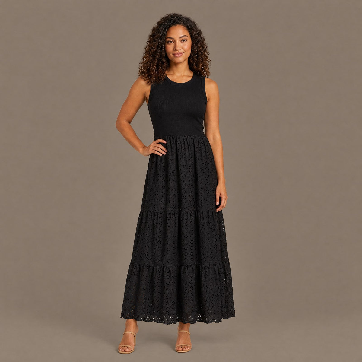 Woman wearing the black ribbed bodice eyelet lace maxi dress, front view