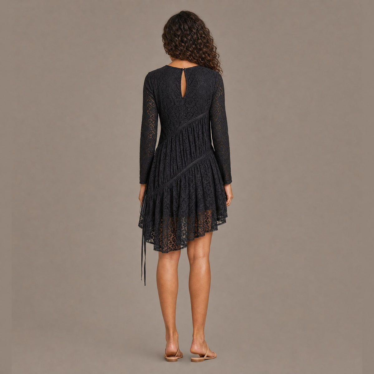 Back view of the coal black ruched tiered lace midi dress